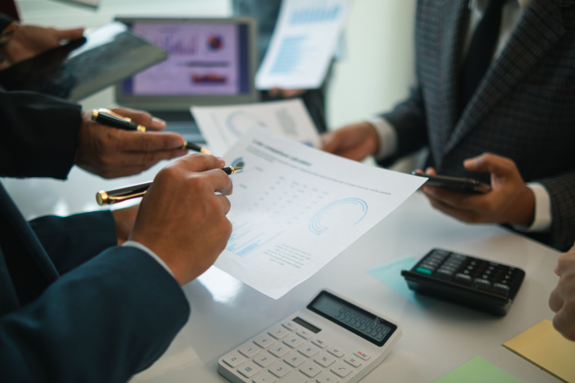 team businessmen are meeting with board of directors  discuss investing real estate and discussing budgets and operating results at meeting. business consultant attending meeting with committee.